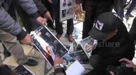 Palestinians burn a portrait of far-right Israeli MP Itamar Ben Gvir during a protest demanding Israel to hand over bodies of Palestinian prisoners who died in Israeli prisons in Hebron in the West Bank