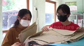 Vietnamese students form paper out of elephant DUNG