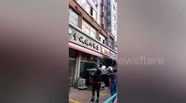Brave men rescue toddler dangling from 2nd-floor window in China