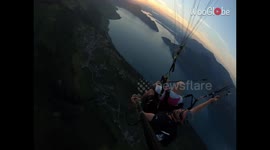 Adrenaline-junkie pulls off INSANE base jump while paragliding over heavenly peaks of Switzerland