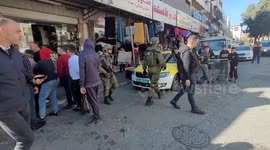 Israeli soldiers close shops in the Old City of the West Bank city of Hebron