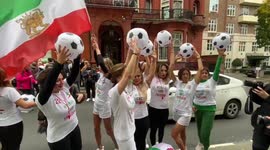 Iranians wearing football shirts promoting women's rights join anti-Qatar rally in London