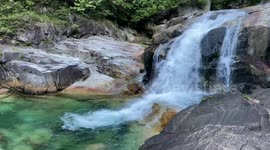 Crystal clear water cascading down a waterfall. Relaxing water flow sound
