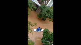 Heavy rain causes flooding in Vietnam, forcing people to travel by boat