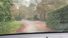 Flooded road in Cornwall in torrential rain after UK weather warning