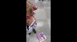 Baby girl sets her sights on buying a bra for herself while shopping with mom