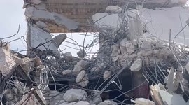 Palestinians walk on the rubbles of their house which was demolished by Israeli forces