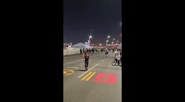 Man juggling discs outside 2022 world cup fan zone in Qatar