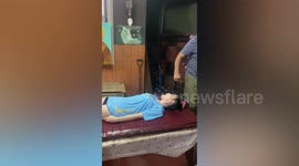 Thai patient receives traditional sore throat cure where herbs are rammed down her throat