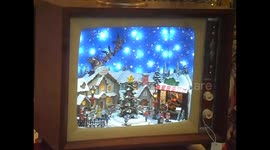 In a toy shop, a TV inside which a Christmas -themed scene takes place