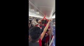 Tunisian fans sing on the Doha metro