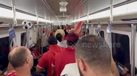 Tunisian fans sing on the Doha metro