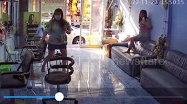 Wild monitor lizard runs into hairdresser's salon in Thailand