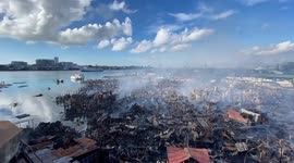 Drone footage shows smouldering ruins following fire in Philippines coastal village