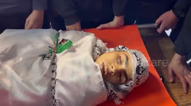 Palestinians carry the body of Ahmad Shehada, 16, was killed after Israeli forces shot him with a live bullet in the heart, during his funeral