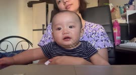 Cheeky toddler covers ears to muffle mum's off-key singing