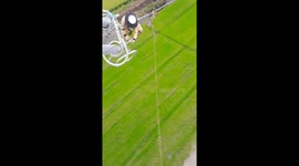 Brave electrician dangles 100 metres in the air as he repairs power lines