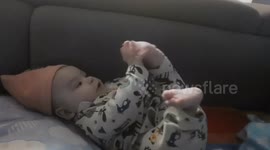 A baby trades a finger for a toy