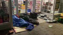 Contrast of living in England: Homeless people sleep in front of Windsor Castle's Christmas display