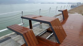 Solid wood tables set up on the banks of the Yangtze River in Yichang, China