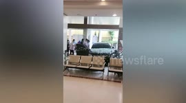 Car rams through hospital glass entrance in Thailand