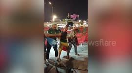 Football fans use man as arrow in front of famous 'Metro Guy' in Qatar