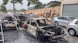Burnt cars which were set on fire overnight are pictured in the Arab village of Abu Gosh