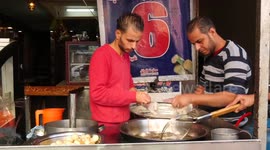 Palestinian vendor prepares traditional sweet called