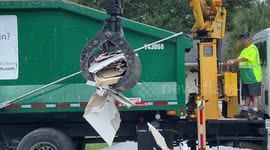 Crane operator pickups debris with the skill of a veteran - making it look like a walk in the park!!