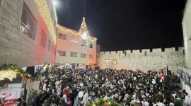 Palestinian Christians take part in a celebration of lighting the Christmas tree and Christmas market