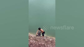 Hero resident climbs down steep bank to rescue dog stranded in reservoir