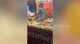 Barbecue seller wears Spider-woman bodysuit to entertain customers