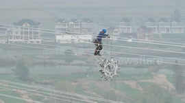 Chinese electricians reconstruct ultra-high voltage lines hundreds of feet above the ground