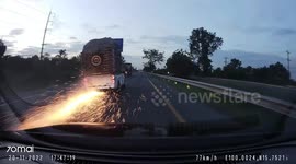 Overloaded pickup truck flips over when tire blows out leaving trail of sparks