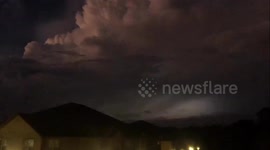 Flickers of lightning illuminate sky over Mississippi as tornado-warned storm strikes