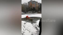 Police and firefighters rescue man who fell through frozen lake in China