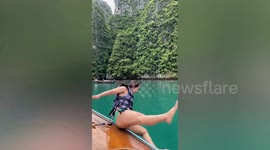 Woman slips while jumping from boat
