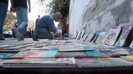 Palestinian Bookseller Mohamed Madi, 62, sells the books on the street, in Gaza city
