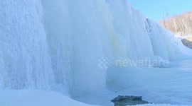 Spectacular scene as waterfall freezes over forest park in China