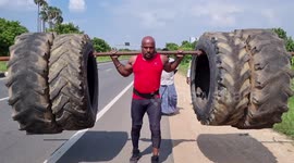 Strong Indian bodybuilder walks with giant tires that weigh almost 350 kg