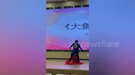 Host accidentally falls onto dancer when walking off stage