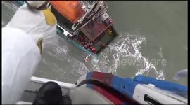 Rescue workers use winch to rescue crew trapped on boat in China