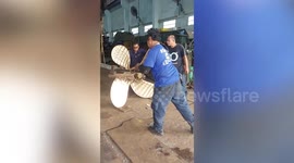 ASMR footage of builders beating huge metal ship motor propeller in Thailand