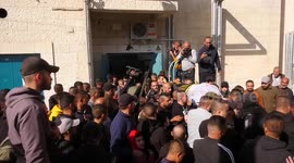 Mourners carry the bodies of Two Palestinian were killed by Israeli forces during their funeral in the West Bank city of Jenin