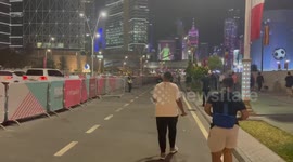 Volunteer World Cup worker directing crowd to metro station after England game.