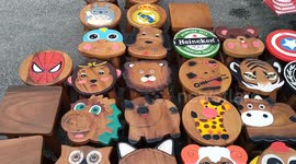 Wooden small stool chairs in animals and brands shape displaying at Night Market Malacca Malaysia