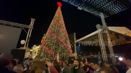 Palestinians in Bethlehem light Christmas tree in Manger Square outside Church of the Nativity