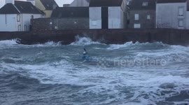 Daredevil brave dangerous storm in a tiny kayak