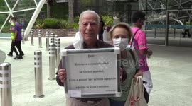Old man shows support for Pelé with framed poster outside hospital in Sao Paulo, Brazil