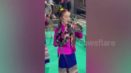 Thai women show how they dance with live cobras stuffed in their mouths